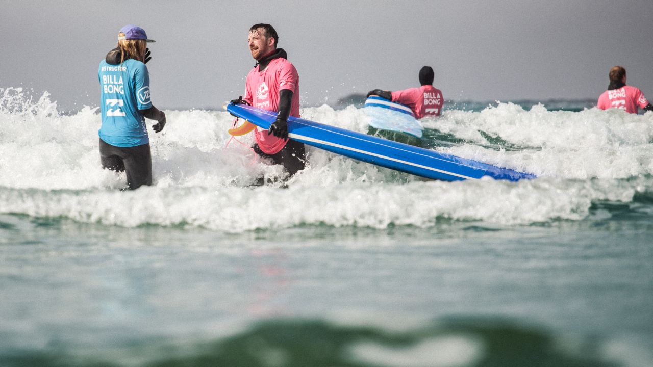 The author (second from left) receives instruction and realizes some people are born surfers. Others, not so much.